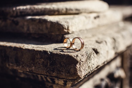 classic gold wedding rings on a white backgroundの写真素材