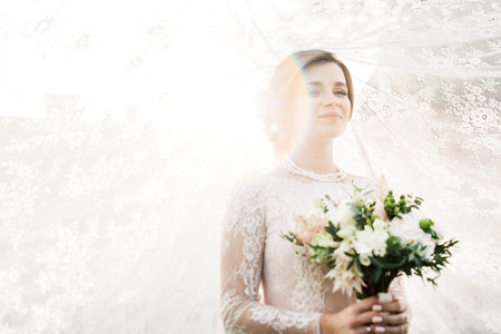 Beautiful bride with wedding flowers bouquet, attractive woman iの写真素材