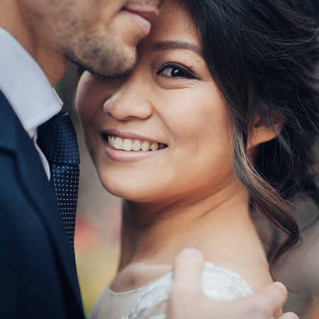 Elegant bride with groom walking near old catholic cathedralの写真素材