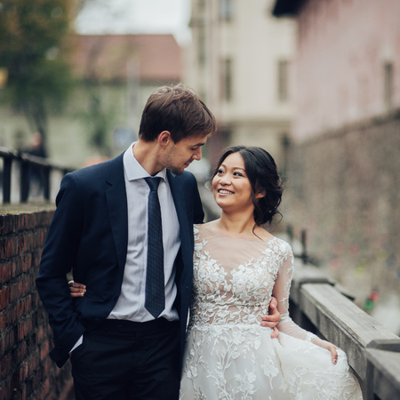 Groom with bride looking at each other in the streetの写真素材