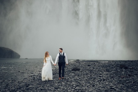 Happy stylish smiling couple walking and kissing in Icelandの写真素材