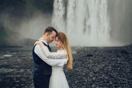 Happy stylish smiling couple walking and kissing in Icelandの写真素材