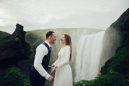 Happy stylish smiling couple walking and kissing in Icelandの写真素材