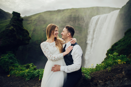 Happy stylish smiling couple walking and kissing in Icelandの写真素材