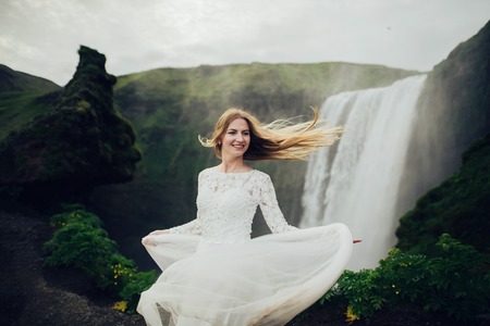 Happy stylish smiling couple walking and kissing in Icelandの写真素材