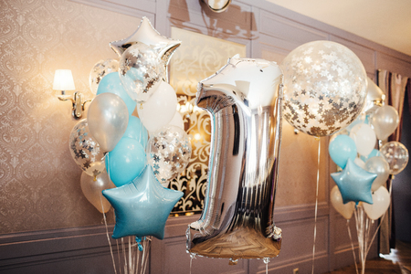 Anniversary or birthday photo zone with white, blue and transparent balloonsの写真素材