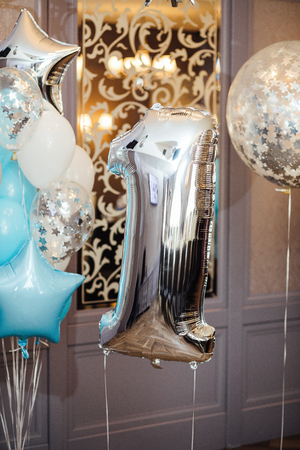 Anniversary or birthday photo zone with white, blue and transparent balloonsの写真素材