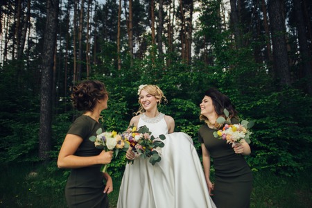 Positive moment of the bride with friends before wedding at foreの写真素材