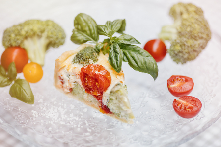 Delicious vegetarian pie and wine , Quiche with  tomatoesの写真素材