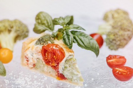 Delicious vegetarian pie and wine , Quiche with  tomatoes