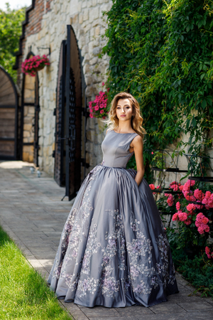 Beautiful girl with roses. Beauty model woman face. Perfect Skinの写真素材