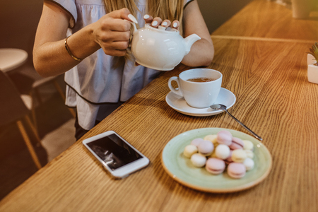 Beautiful young woman is drinking tea in a cafe, the morning.の写真素材