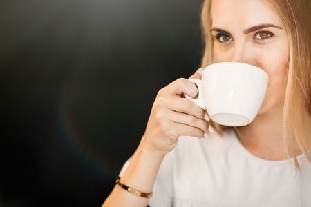Girl drinking tea in the cafe.