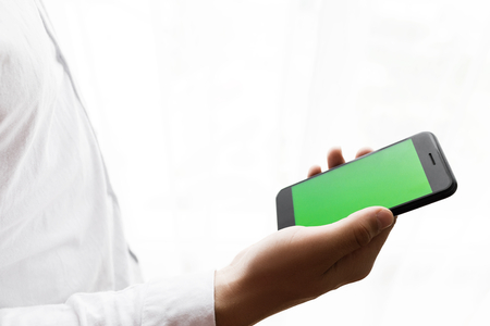 Close-up of male hands using smartphone.の写真素材