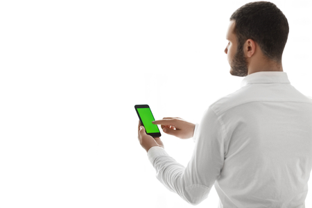 Close-up of male hands using smartphone. Chroma Key.の写真素材