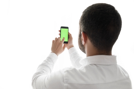 Close-up of male hands using smartphone.の写真素材