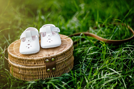 Baby shoes on the grass. Stylish baby shoes with free copy space.の写真素材