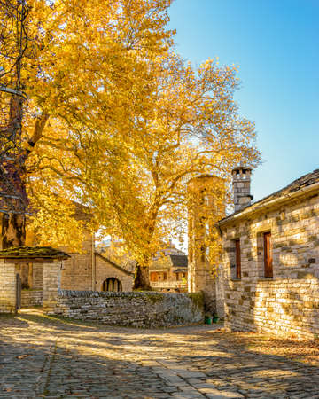Traditional architecture  in a stone street during  fall season in the picturesque village of papigo in Epirus zagori greeceの写真素材