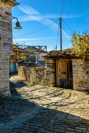 Traditional architecture  in a stone street during  fall season in the picturesque village of papigo in Epirus zagori greeceの写真素材
