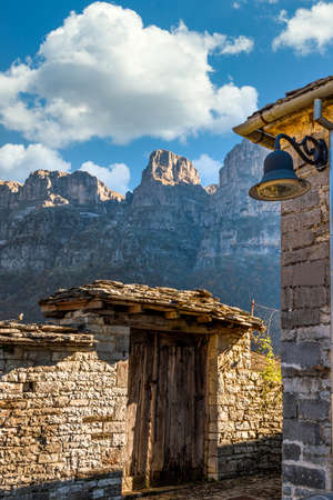 Traditional architecture with  narrow  stone street  and  astraka mountain as background during ...
