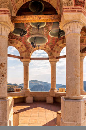 The bell tower of Varlaam monastery, located on a unique rock formation  above the village of Kalambaka during fall season.の写真素材