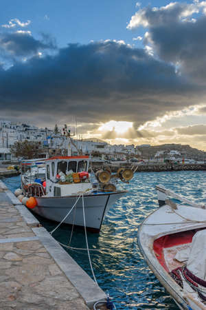 Traditional Cycladitic view with moored traditional fishing boats during an amazing sunset   on the picturesque harbor of Naousa Paros, Greece.の写真素材