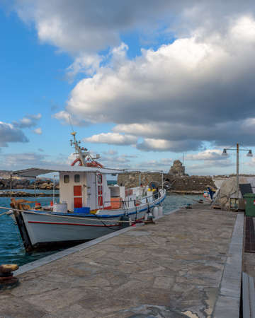 Traditional Cycladitic view with moored traditional fishing boats duringa windy day in the picturesque harbor of Naousa Paros, Greece.の写真素材