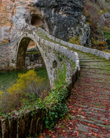 Kokori's old arch stone bridge (Noutsos) during fall season  situated on the river of Voidomatis in  Zagori, Epirus Greece.の写真素材