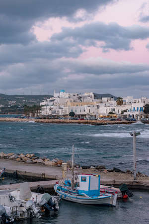 Traditional Cycladitic view with moored traditional fishing boats on a windy day at the picturesque harbor of Parikia Paros, Greece.の写真素材