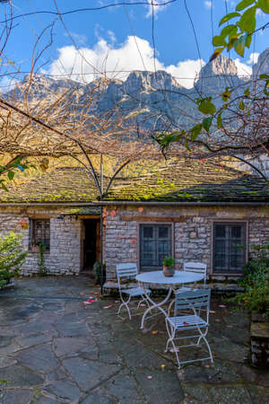view of traditional architecture  with   stone buildings and background astraka mountain during  fall season in the picturesque village of papigo , zagori Greeceの写真素材