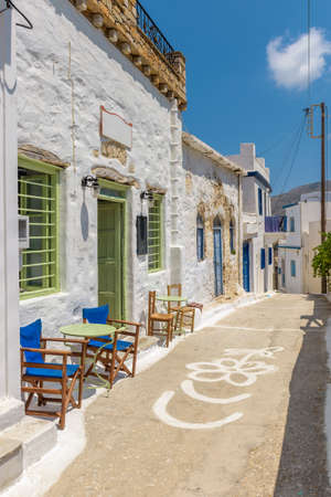 Traditional cycladitic   alley with a narrow street,  whitewashed  houses and an exterior of a cafe  in Lagada, Amorgos  Greeceの写真素材
