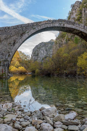 Kokori's old arch stone bridge (Noutsos) during fall season  situated on the river of Voidomatis in  Zagori, Epirus Greece.の写真素材