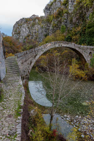 Kokori's old arch stone bridge (Noutsos) during fall season  situated on the river of Voidomatis in  Zagori, Epirus Greece.の写真素材