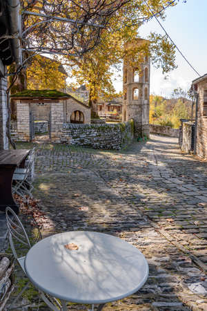 Traditional architecture  in a stone street during  fall season in the picturesque village of papigo in Epirus zagori greeceの写真素材