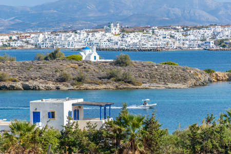 Traditional Cycladitic view of the  whitewashed church of Agia Kalis and the  village of Naousa as ...