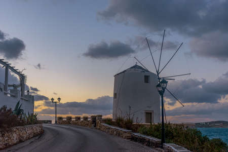 Traditional Cycladitic alley with narrow street, whitewashed church and  flowers in parikia, Paros island, Greece.の写真素材