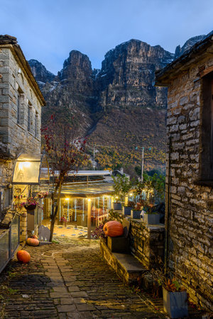 Î¤raditional architecture  with a narrow street and  stone buildings during  fall season in the...
