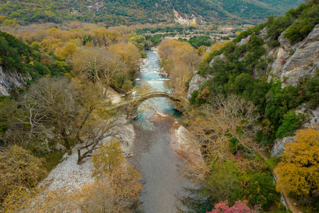 Top down aerial view  of the  old stone bridge in Klidonia  during fall season.  This arch bridge...