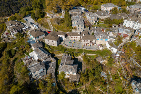 aerial view of the traditional village Mikro Papigo with with stone buildings and  astraka mountain as background during  fall season in  zagori Greeceの写真素材