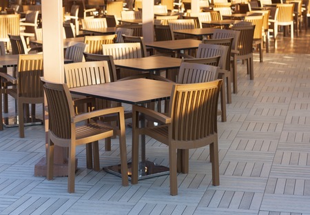 Wooden tables in a outdoor restaurant photoの写真素材