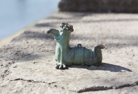 Mini metal sculpture of worm Kukots cartoon character as symbol of fishing photo in Uzhgorod Ukraineの写真素材