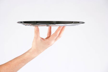 Hand holding steel tray