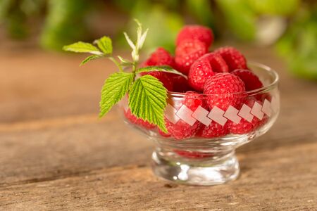 Raspberries on wooden table