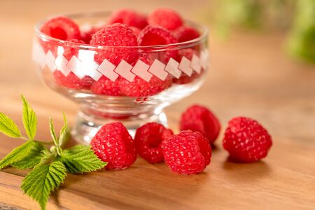 Raspberries on wooden tableの写真素材
