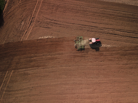 Aerial view of tractor on agricultural fieldの写真素材