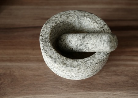 Empty stone mortar on wooden tableの写真素材