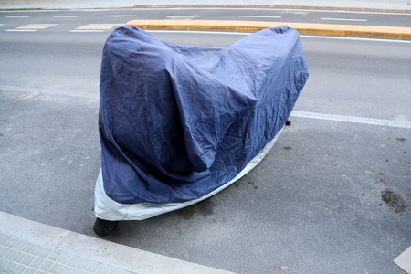 Motorbike with cover standingの写真素材