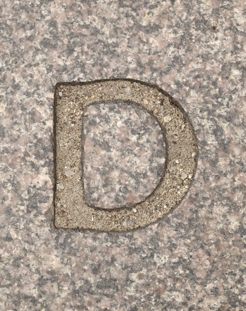 Letter D. On stone backgroundの写真素材