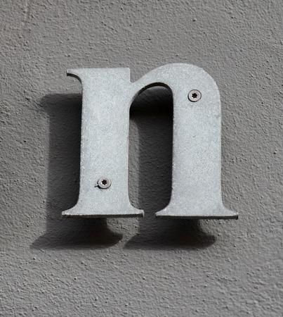 Letter n. On brown background