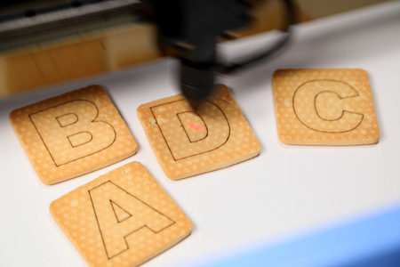 Industrial laser engraving letter Dの写真素材